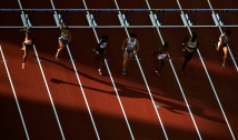 ATHENS - AUGUST 23: Athletes compete in the women's 100 metre hurdle semifinal on August 23, 2004 during the Athens 2004 Summer Olympic Games at the Olympic Stadium in the Sports Complex in Athens, Greece. (Photo by Donald Miralle/Getty Images)