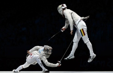 LONDON, ENGLAND - AUGUST 3: Eunseok Oh of South Korea competes against Florin Zalomir of Romania during the Men's Fencing Team Sabre Bronze and Gold Medal Final Day 7 of the London 2012 Olympic Games on August 3, 2012 at the Excell Center in London, England. (Photo by Donald Miralle)